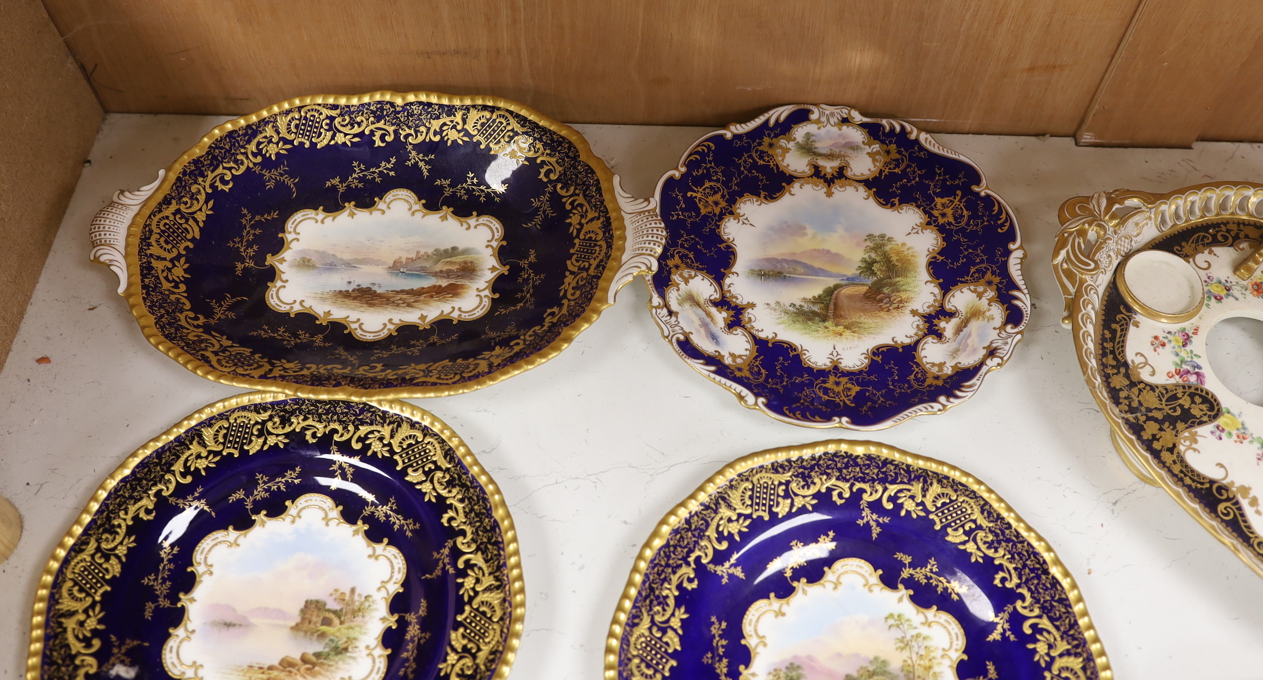 Four 19th century Coalport plates, a Coalport dish, a Minton plate, a Coalport inkstand in Chelsea style and a Derby cache pot, ink stand 40cms wide